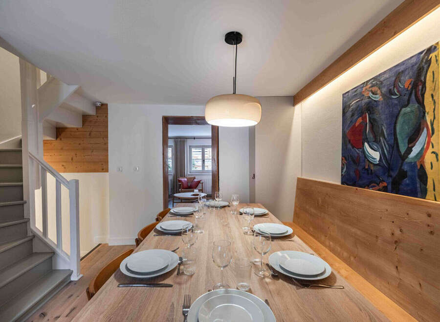 This stunning dining area showcases a beautifully crafted wooden table, perfect for hosting gatherings.