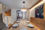 This stunning dining area showcases a beautifully crafted wooden table, perfect for hosting gatherings.