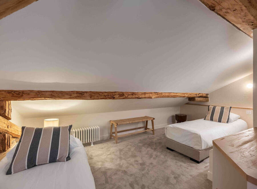 This charming bedroom features a cozy and inviting atmosphere, perfect for a relaxing retreat.