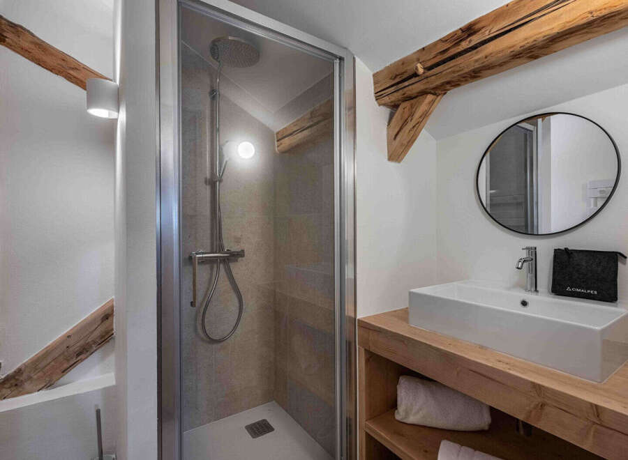 This charming bathroom features a modern shower and a stylish vanity.