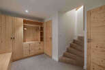 This stunning property boasts a beautifully crafted wooden wardrobe and a staircase leading to the upper levels.