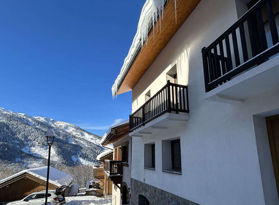 Experience the charm of a winter wonderland with this stunning property nestled in a snowy mountain landscape.