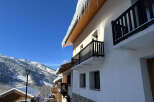 Experience the charm of a winter wonderland with this stunning property nestled in a snowy mountain landscape.