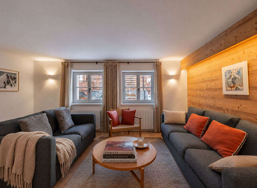 Experience cozy mountain living in this charming living room, featuring two comfortable sofas perfect for relaxation.