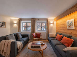 Experience cozy mountain living in this charming living room, featuring two comfortable sofas perfect for relaxation.