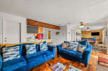 Step into this cozy living space, featuring plush blue sofas and a unique wooden coffee table.