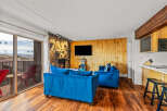 This stunning property boasts a cozy living area with a fireplace and a modern TV, perfect for relaxing evenings.