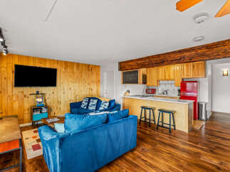 This stunning property boasts a cozy living area with a plush blue sofa, perfect for relaxing.