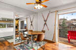 This charming property features a cozy dining area with a round wooden table and stylish chairs, perfect for enjoying meals.