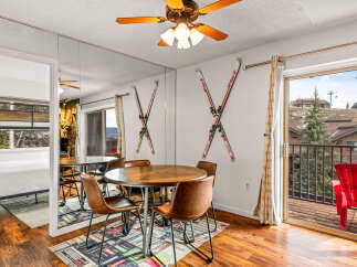 This charming property features a cozy dining area with a round wooden table and stylish chairs, perfect for enjoying meals.