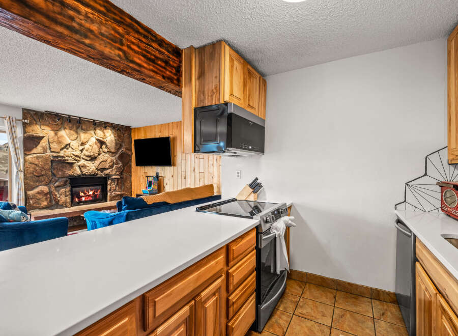 This stunning property boasts a cozy living space with a stone fireplace, perfect for relaxing evenings.