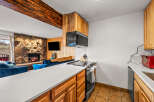 This stunning property boasts a cozy living space with a stone fireplace, perfect for relaxing evenings.