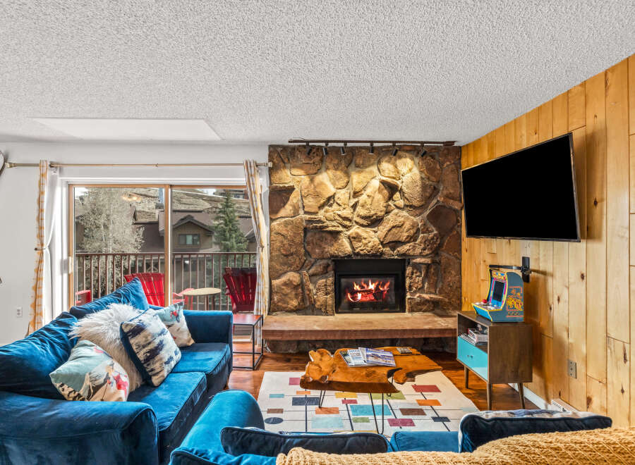 Experience the warmth of this inviting living space, featuring a cozy fireplace and a stylish entertainment area.