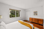 This inviting bedroom features a cozy atmosphere with a comfortable bed and a warm, textured throw.
