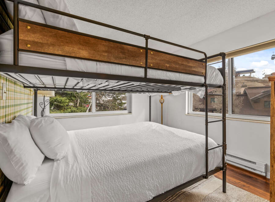 This cozy bedroom features a stylish bunk bed, perfect for accommodating guests or family.
