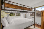 This cozy bedroom features a stylish bunk bed, perfect for accommodating guests or family.