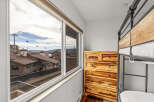 Enjoy stunning mountain views from this cozy bedroom! This space features a beautiful wooden dresser and a stylish bunk bed, perfect for a vacation rental or a family home.
