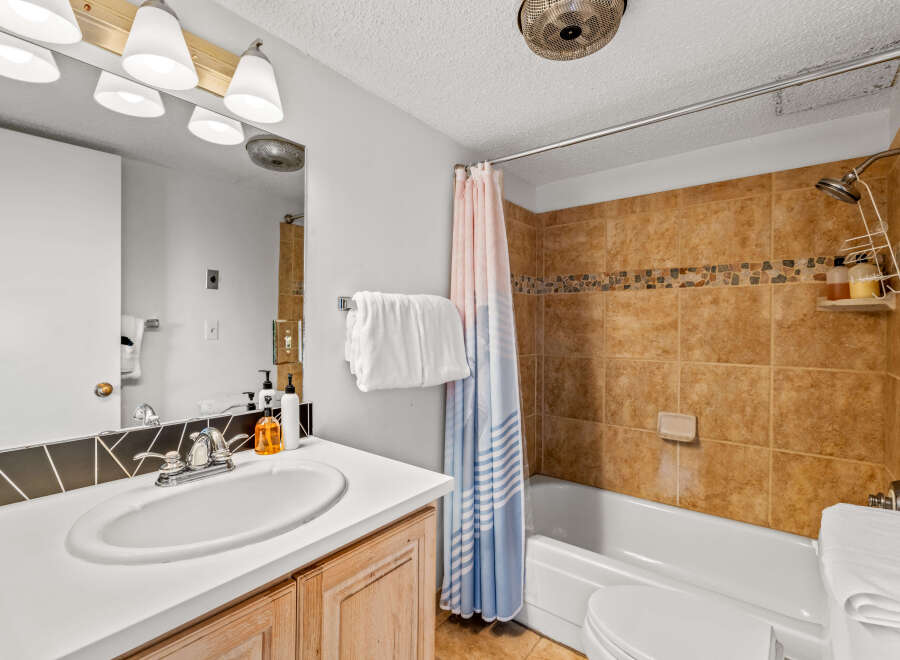 This bathroom features a clean and modern design with a white countertop and a stylish sink.