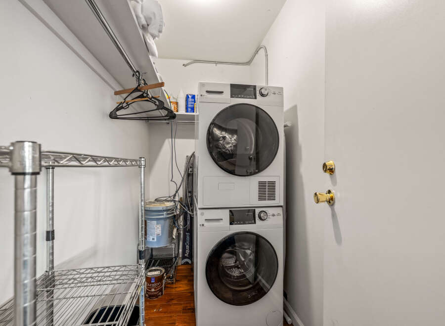This laundry room features a modern stacked washer and dryer, maximizing space and efficiency.