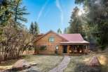 Nestled in a serene natural setting, this charming log cabin offers a perfect blend of rustic charm and modern comfort.
