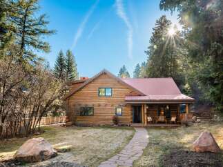 Nestled in a serene natural setting, this charming log cabin offers a perfect blend of rustic charm and modern comfort.