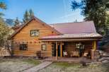 Nestled in a serene natural setting, this stunning log cabin offers a perfect blend of rustic charm and modern comfort.