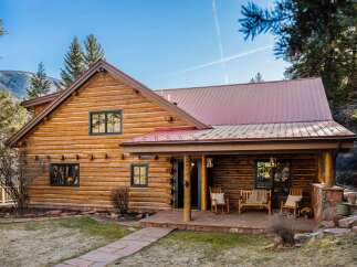 Nestled in a serene natural setting, this stunning log cabin offers a perfect blend of rustic charm and modern comfort.