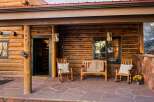 Step into rustic charm with this inviting log cabin porch.