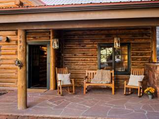 Step into rustic charm with this inviting log cabin porch.