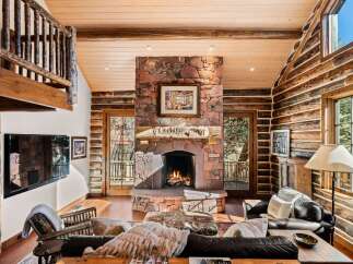 Step into rustic luxury with this stunning log cabin living room.