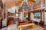 This stunning property boasts a rustic charm with its exposed log walls and wooden accents throughout.