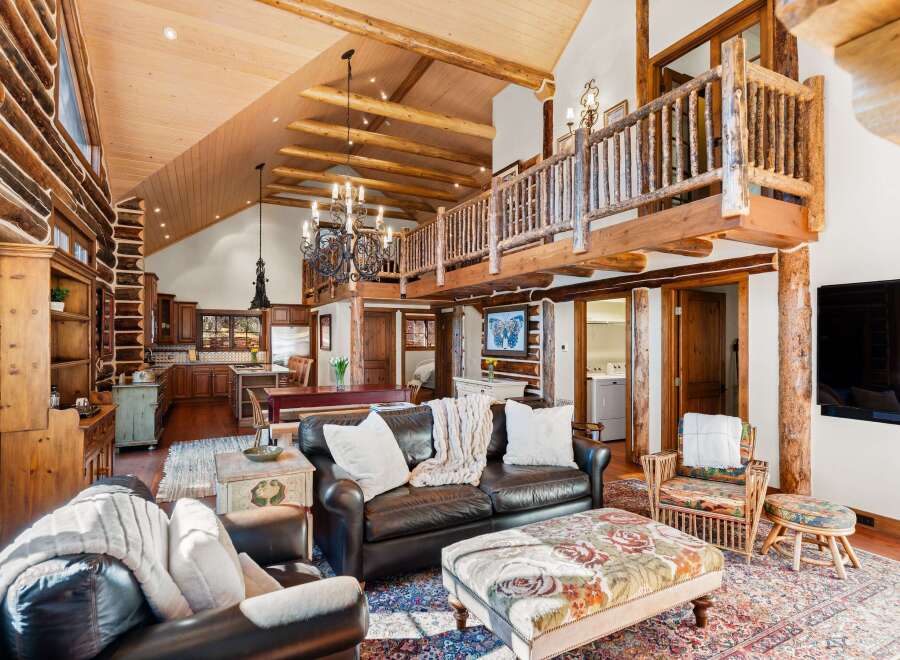 Step into luxury with this stunning log cabin home, boasting a grand open floor plan and exquisite wooden details throughout.