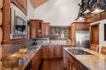 This stunning kitchen boasts custom cabinetry, granite countertops, and stainless steel appliances.