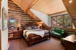 This stunning bedroom features a rustic log cabin aesthetic, perfect for a cozy retreat.