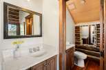 This charming bathroom features a rustic design with wooden accents and a marble countertop.