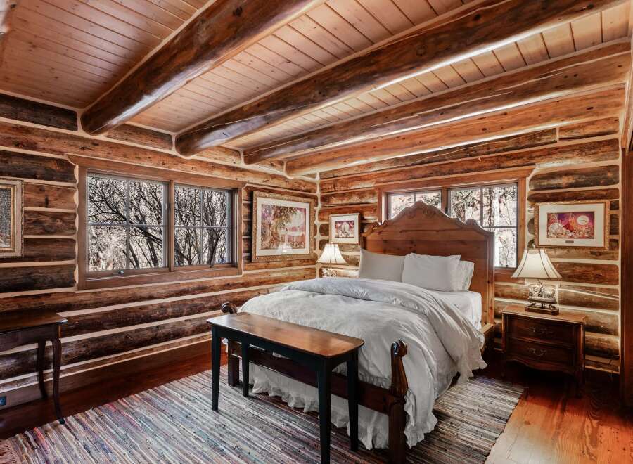 Step into rustic elegance in this stunning log cabin bedroom.