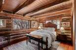 Step into rustic elegance in this stunning log cabin bedroom.