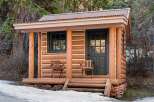 This charming cabin offers a rustic retreat with its log construction and inviting porch.