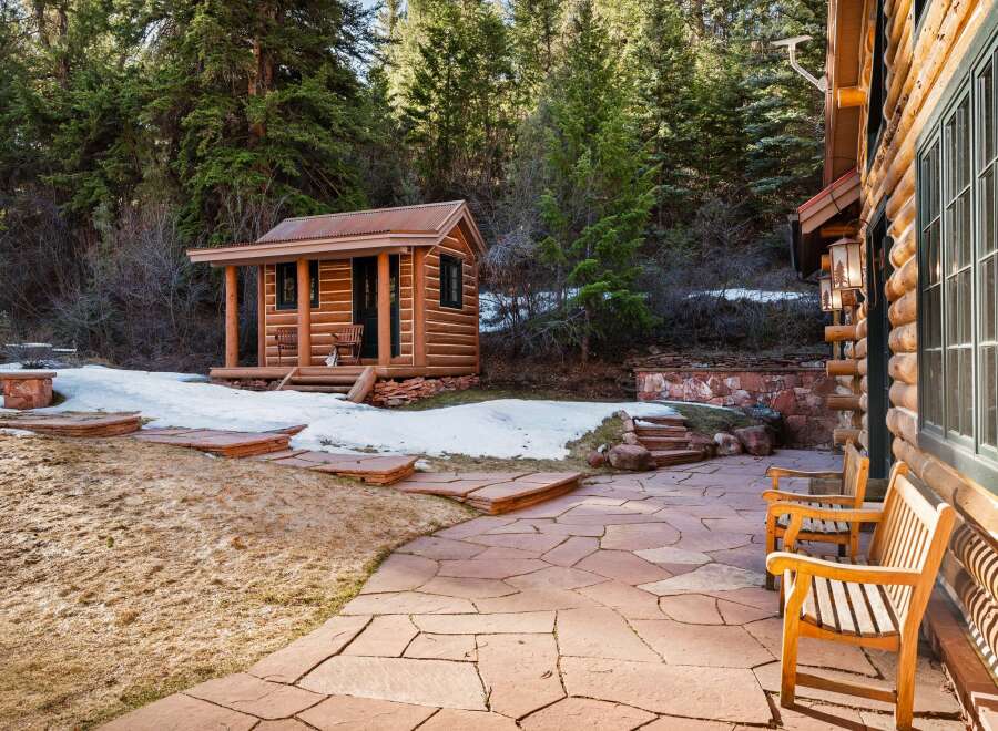 Nestled in a serene natural setting, this property boasts a charming log cabin with a rustic aesthetic.