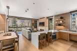 Experience luxury living in this stunning property, featuring a modern kitchen with a sleek island and high-end appliances.