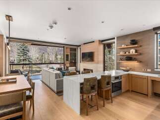 Experience luxury living in this stunning property, featuring a modern kitchen with a sleek island and high-end appliances.