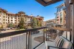 Enjoy stunning views from this luxurious balcony overlooking a beautiful mountain resort.