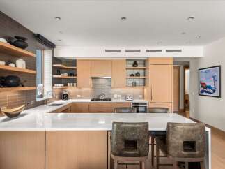 This stunning kitchen boasts a modern design with sleek cabinetry and a spacious island, perfect for both cooking and entertaining.
