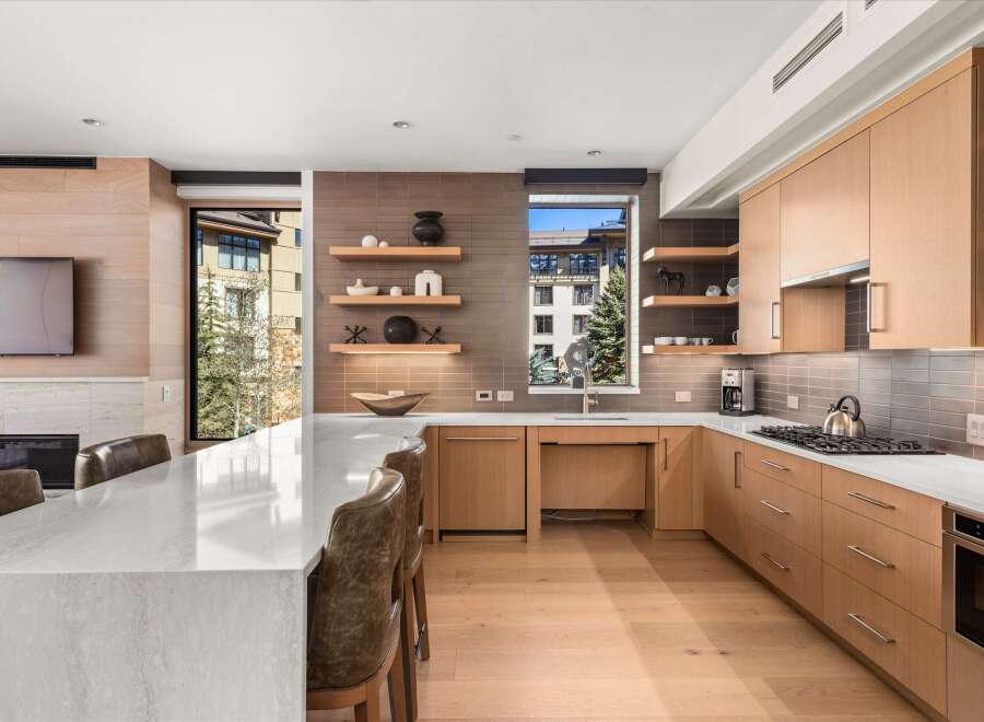 This stunning kitchen boasts a modern design with sleek cabinetry and a spacious layout, perfect for culinary enthusiasts.