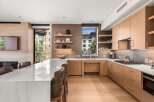This stunning kitchen boasts a modern design with sleek cabinetry and a spacious layout, perfect for culinary enthusiasts.