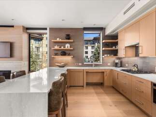 This stunning kitchen boasts a modern design with sleek cabinetry and a spacious layout, perfect for culinary enthusiasts.