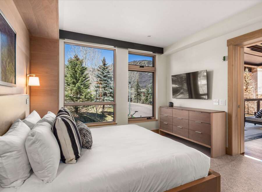 Experience luxury in this stunning bedroom featuring a modern design and breathtaking views.