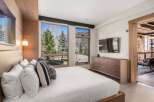 Experience luxury in this stunning bedroom featuring a modern design and breathtaking views.