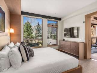 Experience luxury in this stunning bedroom featuring a modern design and breathtaking views.
