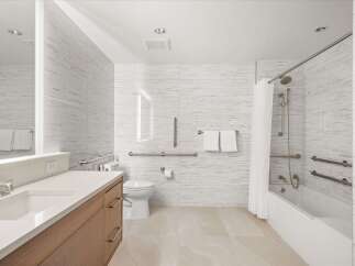 This modern bathroom features a sleek design with a focus on accessibility.